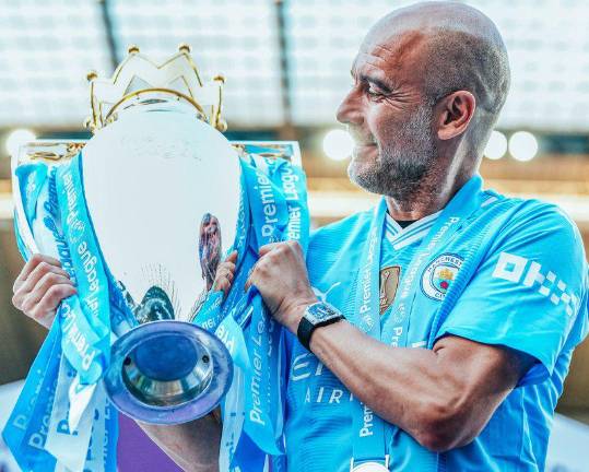 El técnico del Manchester City Pep Guardiola posa con el trofeo de la Premier League conquistada después de ganar al West Ham United en el Etihad Stadium de Mánchester.