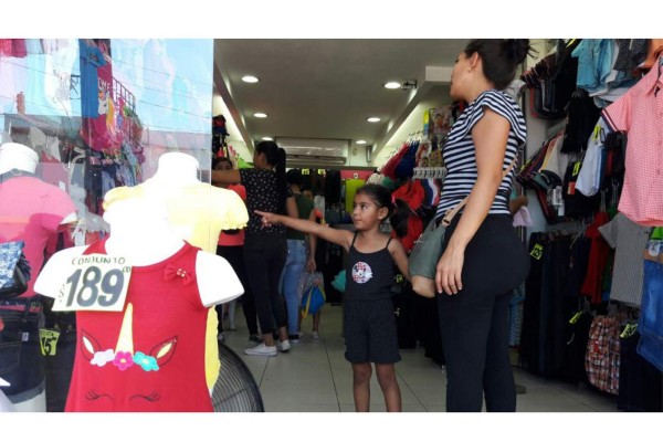 Los padres e familia acudieron a tiendas de ropa y calzado para comprar algo para que los niños estrenen en su día.