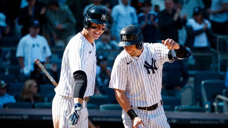 Anthony Rizzo, quien aquí felicita a un compañero, comandó la ofensiva de los Yanquis.