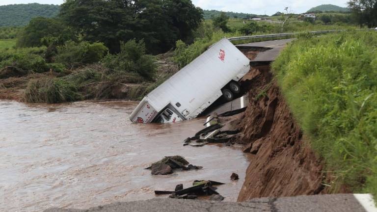 El tráiler caído en el puente auxiliar.