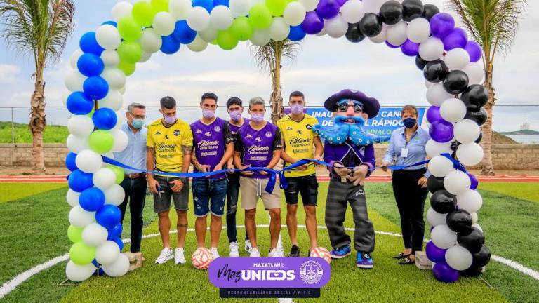 Los jugadores de Mazatlán FC al momento de cortar el listón de la cancha de pasto sintético.