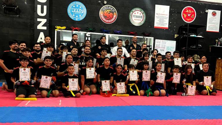 Con orgullo los alumnos muestran su certificación de ascenso de grado.